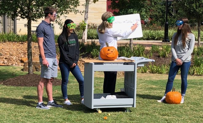 Chemistry teacher Cathy Mock surprised STEM Society students at The John Cooper School with a science experiment that “self-carved” Halloween pumpkins.