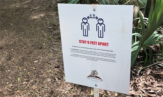 The Woodlands Township 6 feet apart sign