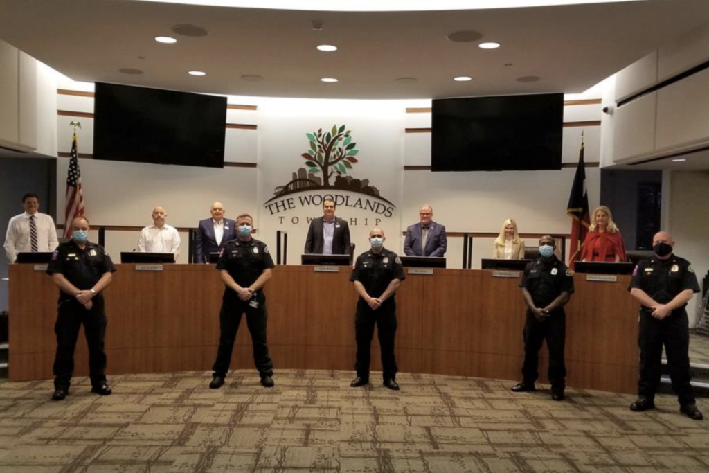 The Woodlands Township Board of Directors recognized The Woodlands Fire Department for their role in saving the life of ninth-grader Julieta Valdes after she experienced Sudden Cardiac Arrest, resulting in loss of pulse for 23 minutes. Front row, left to right: Lieutenant/EMT-Advanced Bill Holt, Firefighter/EMT-Basic Gary Rogers, Firefighter/EMT-Paramedic Travis Nicholson, Cadet Firefighter/EMT-Basic Reggie Jackson, and Battalion Chief/EMT-Advanced Mitch Hubbard. Back row, left to right: Director Jason J. Nelson, Treasurer John Anthony Brown, Vice Chairman Bruce Rieser, Chairman Gordy Bunch, Director Bob Milner, Director Dr. Ann K. Snyder, and Secretary Dr. Shelley Sekula-Gibbs.