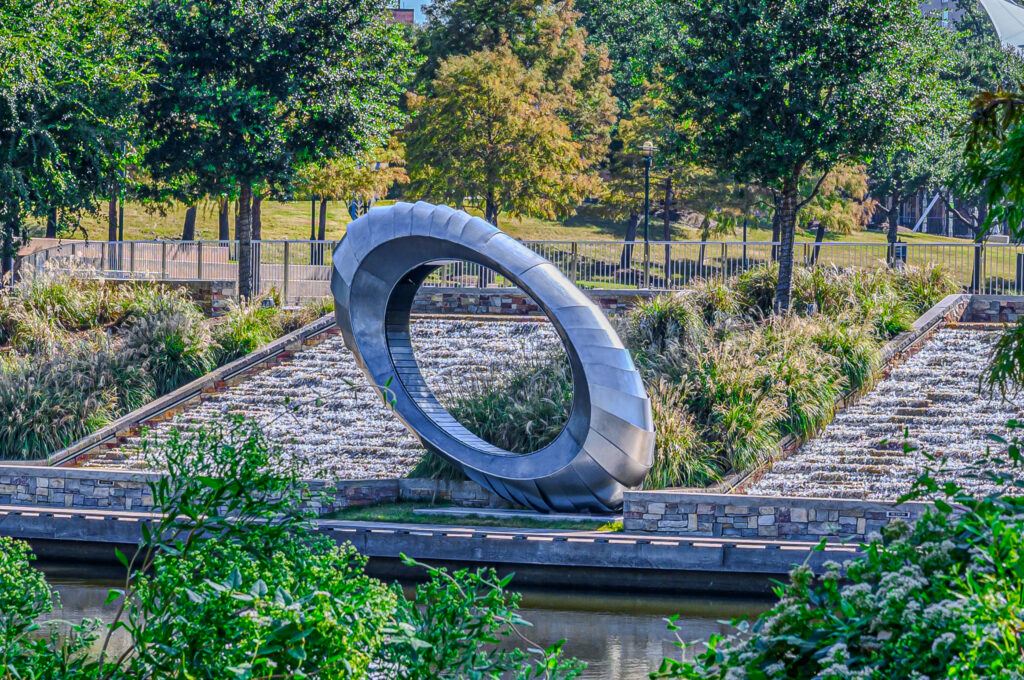 Visit the Mystical Senses Art Bench at the base of the waterfalls on The Woodlands Waterway
