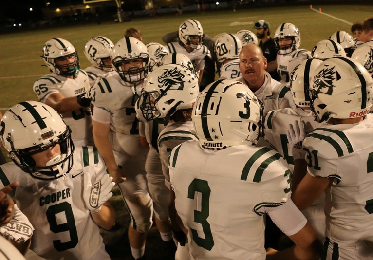 The John Cooper School Varsity Football huddle with Head Coach Erik DeHaven 2021