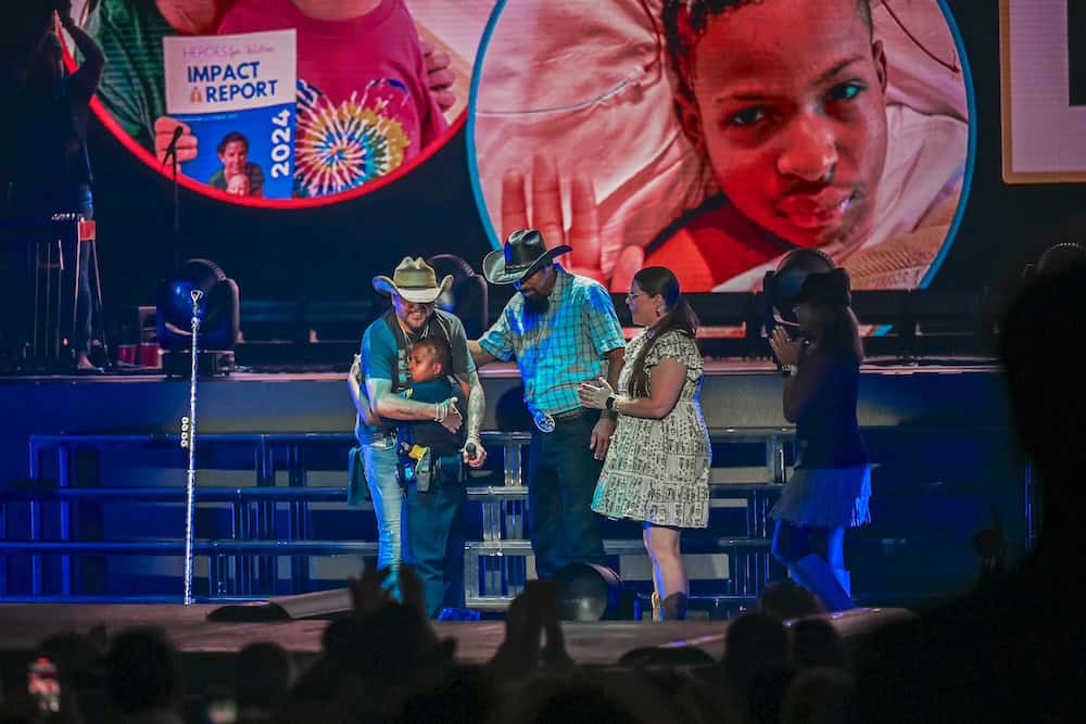 Jason Aldean with 13 year old Heroes For Children advocate DJ Daniel on stage at The Cynthia Woods Mitchell Pavilion’s Full Throttle Tour Date on August 15th; Photo Credit: The Cynthia Woods Mitchell Pavilion