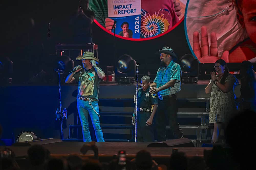 Jason Aldean with 13 year old Heroes For Children advocate DJ Daniel on stage at The Cynthia Woods Mitchell Pavilion’s Full Throttle Tour Date on August 15th; Photo Credit: The Cynthia Woods Mitchell Pavilion