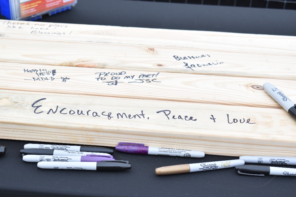 Attendees sign the studs of future Marble Creek homes