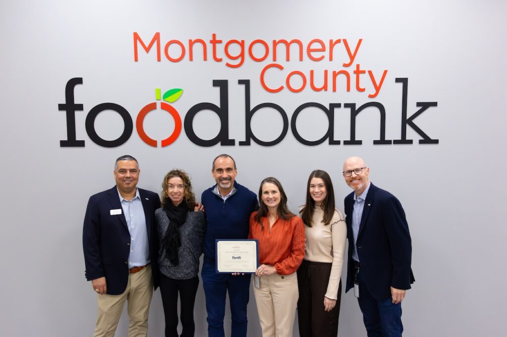 Kristine Marlow, President & CEO of Montgomery County Food Bank, presents Massimo Bizzi, CEO, Fortifi Food Processing Solutions, with their “2026 Volunteer of the Year” recognition.