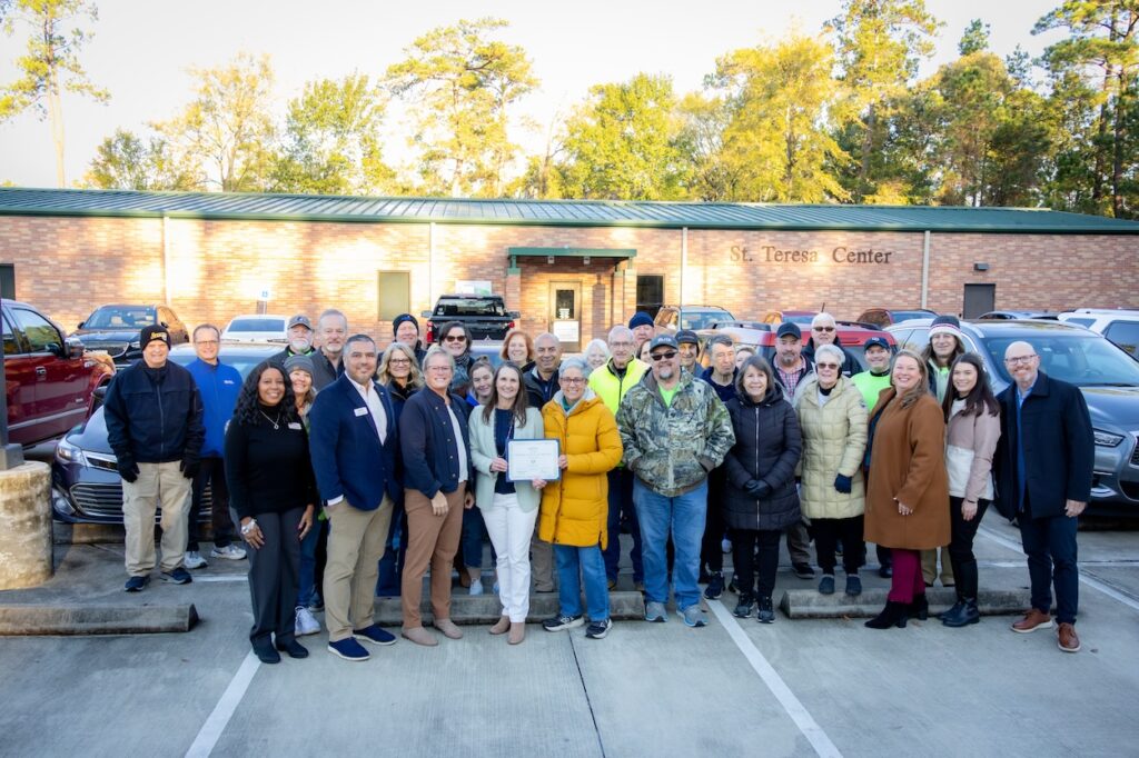Kristine Marlow, President & CEO of Montgomery County Food Bank, announces the “Partner Agency of the Year” recognition to St. Anthony staff and volunteers.