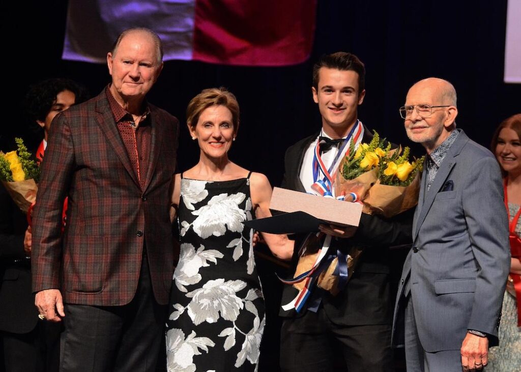 Former Conroe Mayor Tommy Metcalf (far left) presented Young Texas Artists Grand Prize winner Cirdan Vonnahme with a flag that flew over the State Capitol building on Texas Independence Day. Metcalf made the presentation on behalf of his son, State Representative Will Metcalf. Shown with them are YTA President/CEO Susie Pokorski and YTA founder Jim Pokorski. Photo by David Hopper.