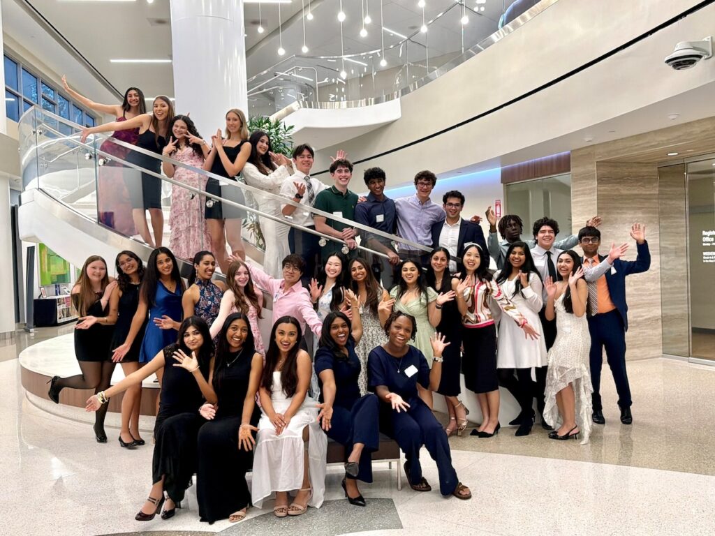 Members of this year’s graduating Junior Volunteers from Memorial Hermann The Woodlands along with Junior Volunteer Program Coordinator Jason Kwok (center, in pink shirt).