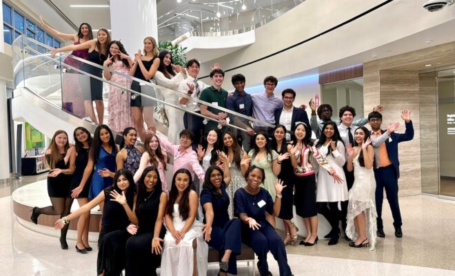 Members of this year’s graduating Junior Volunteers from Memorial Hermann The Woodlands along with Junior Volunteer Program Coordinator Jason Kwok (center, in pink shirt).