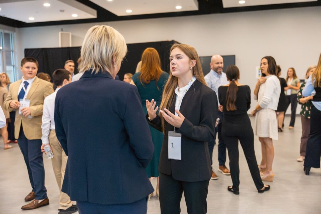 TWCA Student Communicates in the Mix and Mingle at The Harvest 2026.