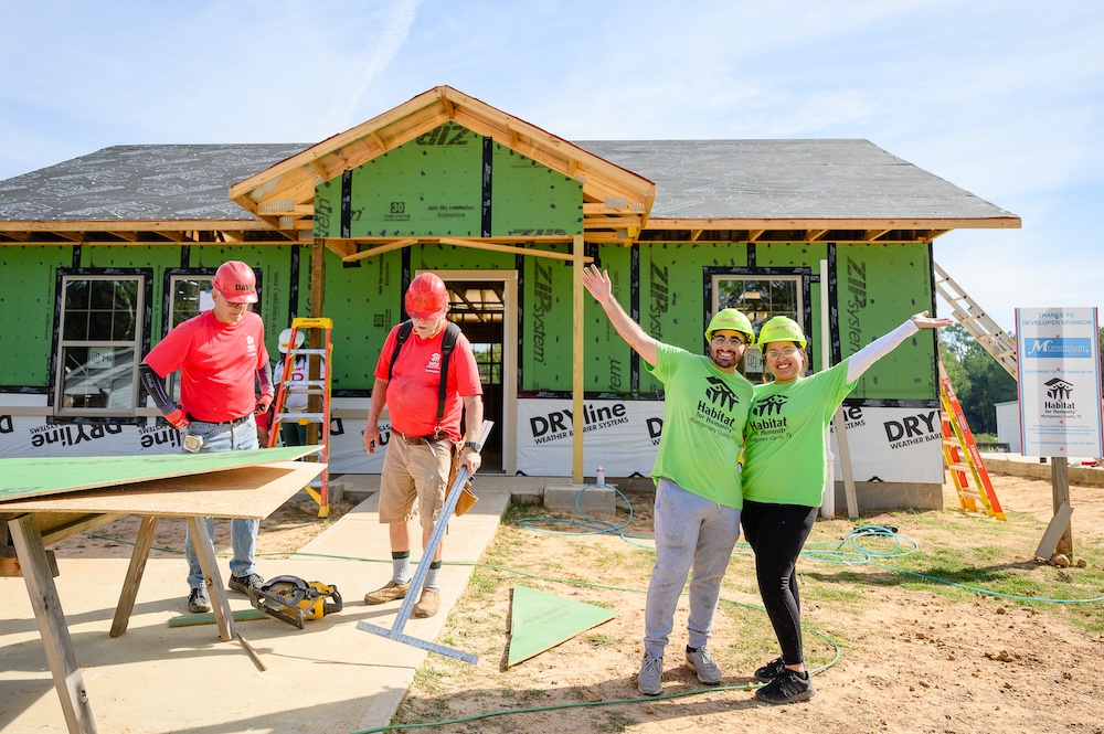 Future Habitat homeowners work alongside volunteers to build their home