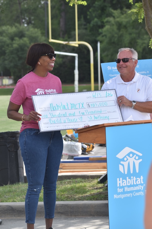 Habitat for Humanity's Vicki Johnson receiving check from St. Anthony of Padua Catholic Church