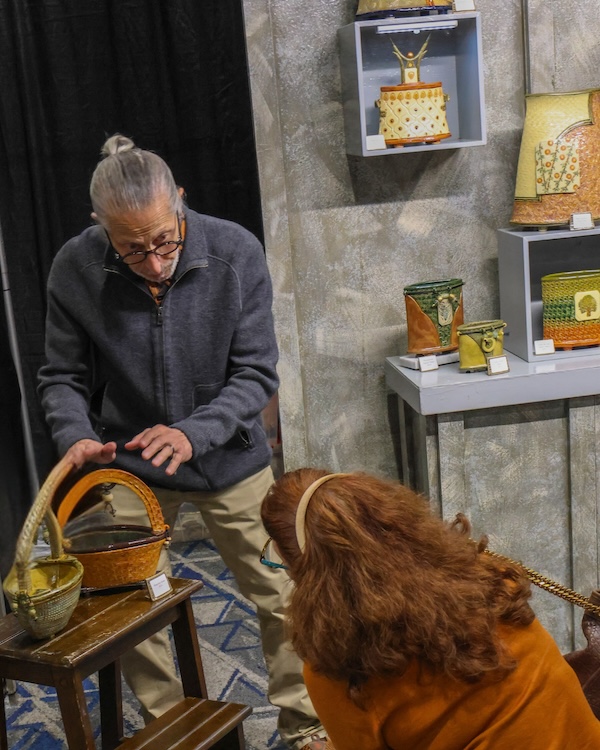 Ceramist Richard Mayer visits with a customer during the 2025 Texas Fine Craft Show. (Photo credit: Rod Prado)