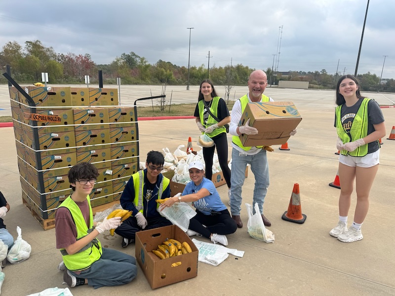 Dr. David Vinson (second from right) volunteers alongside Conroe ISD staff and students on November 8, 2025, at a Montgomery County Food Bank mobile distribution