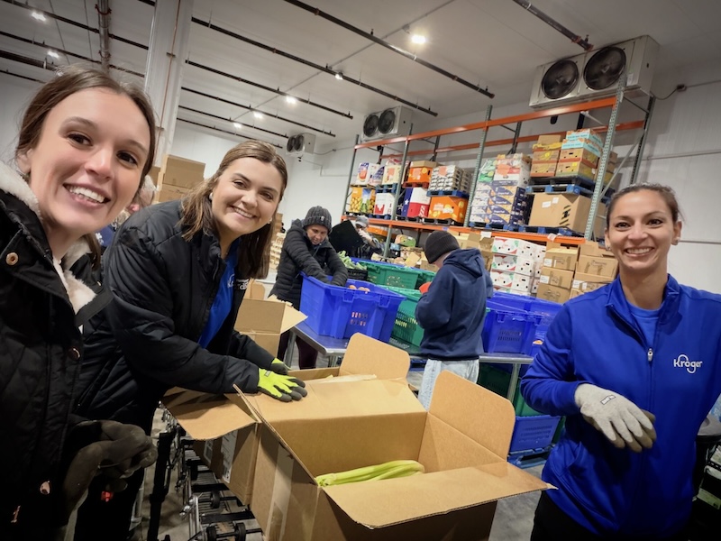Kaylea Williams (far left) volunteers at Montgomery County Food Bank alongside her Kroger coworkers, sorting and packing fresh produce in the Howard Hughes Produce Rescue Center.